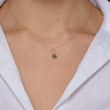 14K gold necklace with engraved initial M on round disc charm and twisted loop detail