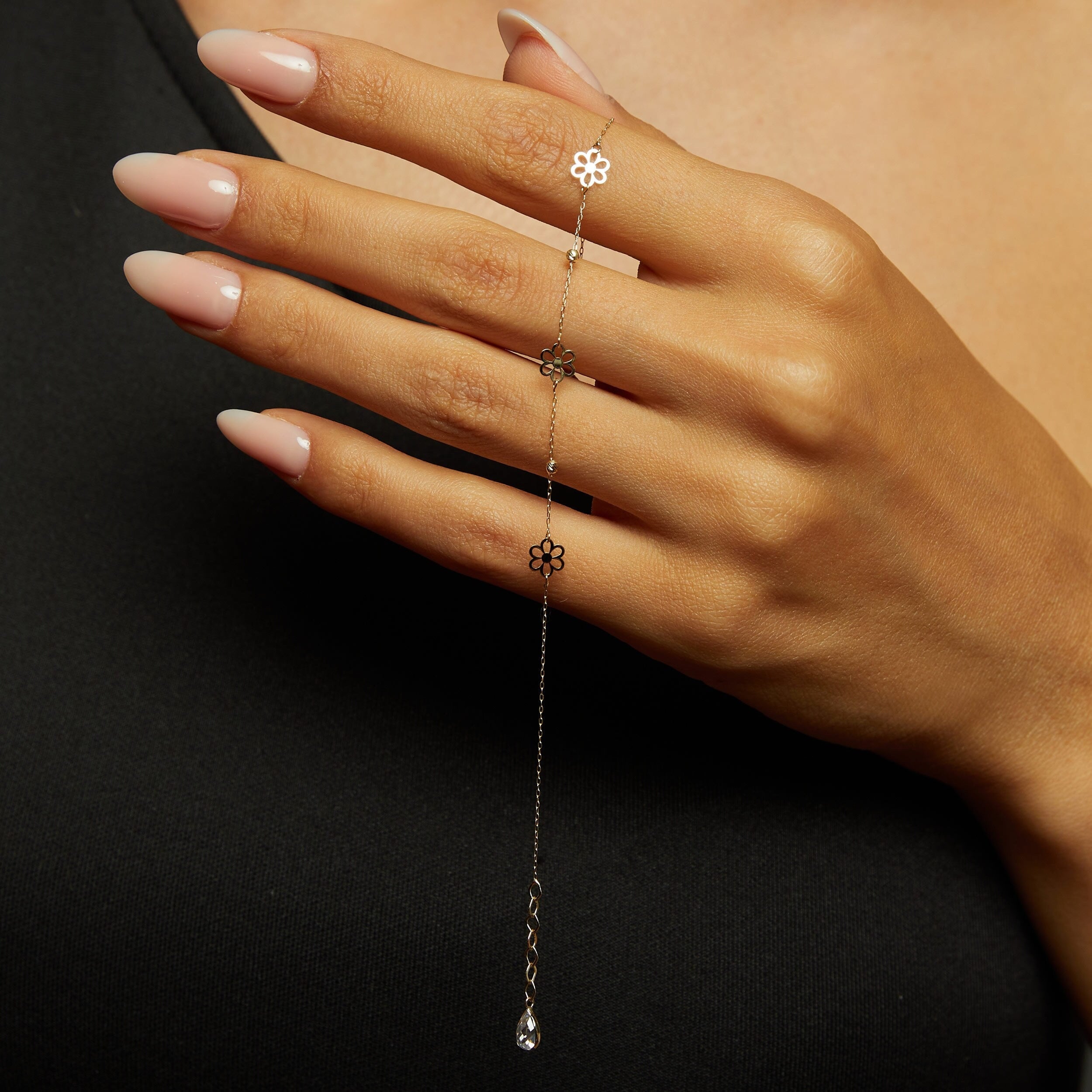 14K gold bracelet featuring three dainty flower charms and bead accents