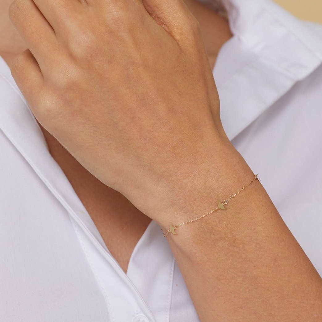 Minimal 14K gold bracelet with flying bird charms