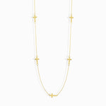 14K gold necklace with multiple small cross charms elegant and minimalistic.