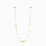 14K gold necklace with multiple small cross charms elegant and minimalistic.