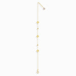 Minimalist 14K gold bracelet with clover-shaped charms and tiny textured accents, styled on emerald green silk fabric