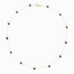 14K gold necklace with five blue and yellow enamel evil eye charms, representing protective jewelry.