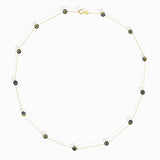 14K gold necklace with five blue and yellow enamel evil eye charms, representing protective jewelry.