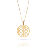 14K gold Flower of Life pendant necklace on deep purple fabric – sacred geometry jewelry with spiritual symbolism.