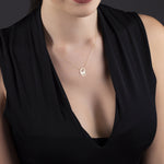 14K gold necklace with two giraffes forming a heart shape,