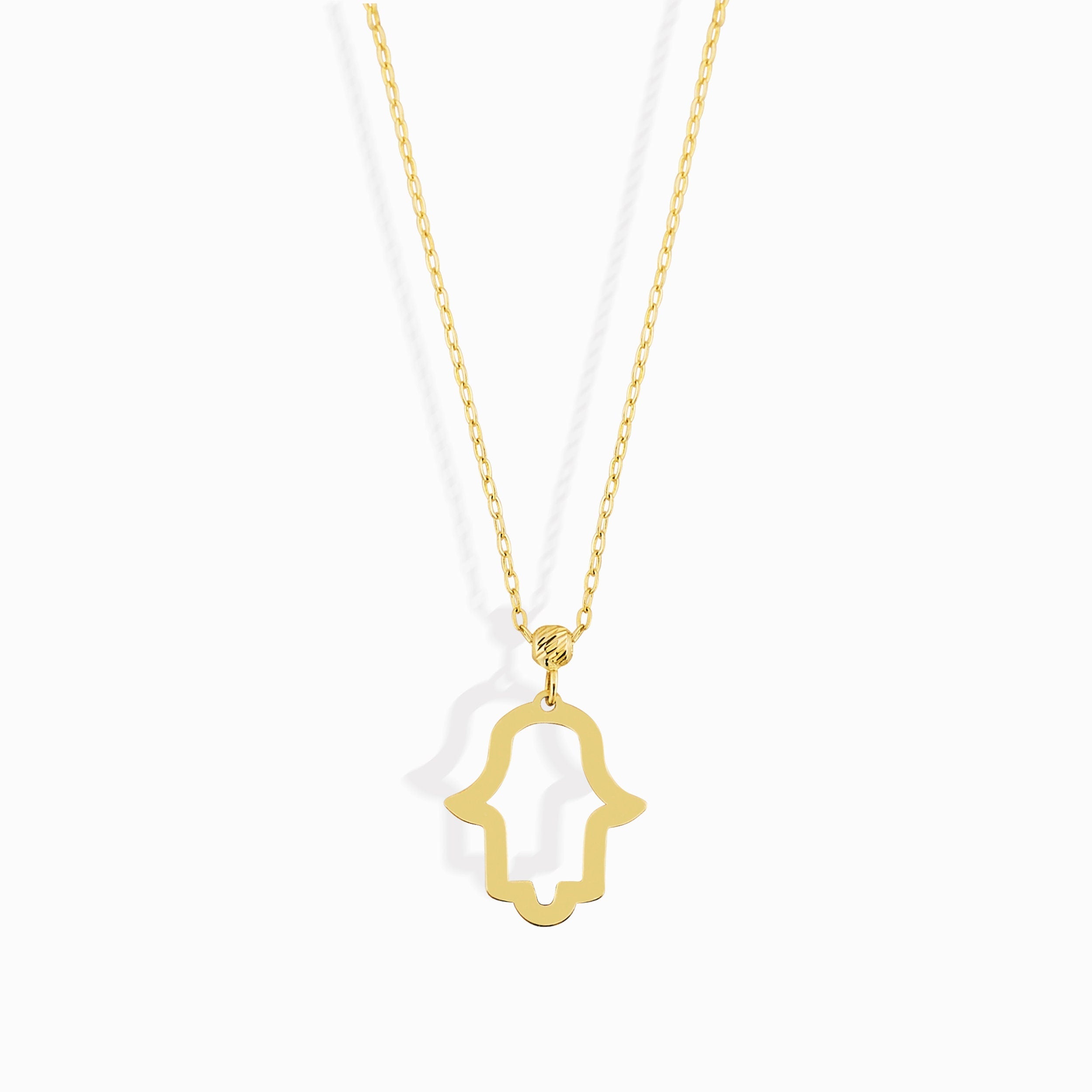 14K gold Hamsa hand necklace on emerald