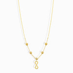 Minimalist 14K gold necklace with an infinity pendant and textured beaded chain,