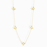 Minimalist 14K gold necklace with three evenly spaced clover charms,