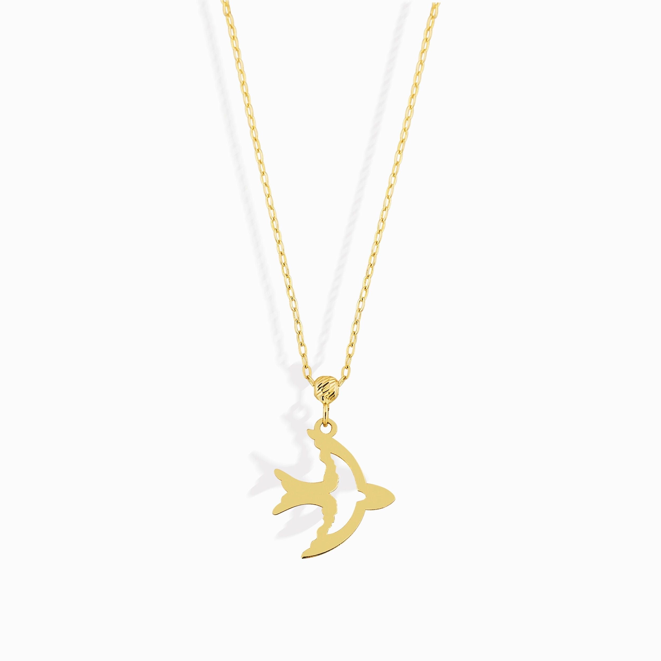 14K gold necklace with a flying bird pendant, graceful, and symbolic design.