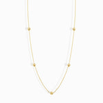 Minimalist 14K solid gold necklace with round beads spaced along a fine chain,