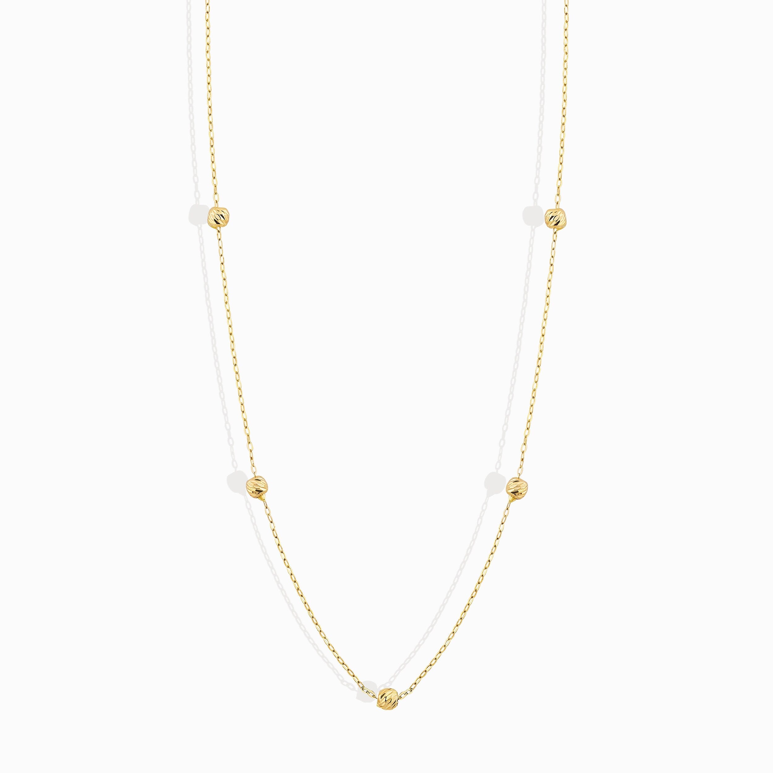 Minimalist 14K solid gold necklace with round beads spaced along a fine chain,
