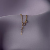 Elegant 14K gold bracelet featuring a snowflake charm and crystal bead accents