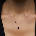 14K gold necklace with bird charm and blue sapphire teardrop pendant