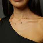 Minimalist 14K gold bracelet with flying bird charms on model’s