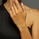 14K gold bracelet featuring three dainty flower charms and bead accents