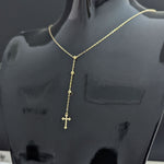 Close-up image of a 14K gold rosary-style necklace with a delicate cross pendant