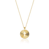 Minimalist 14K gold medallion necklace with a central cutout cross and radiant sunbeam engravings