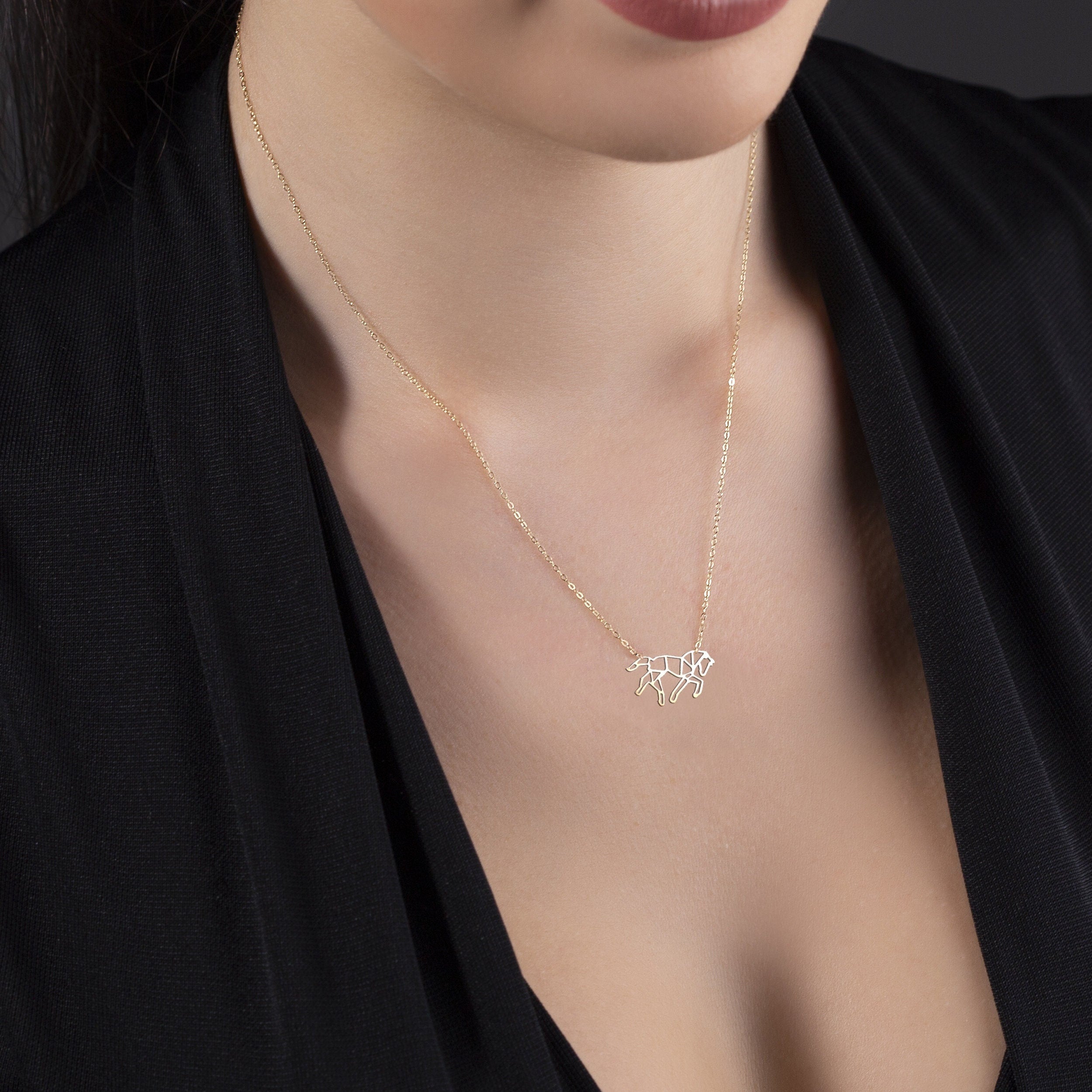 Minimalist 14K gold necklace with a geometric horse pendant,