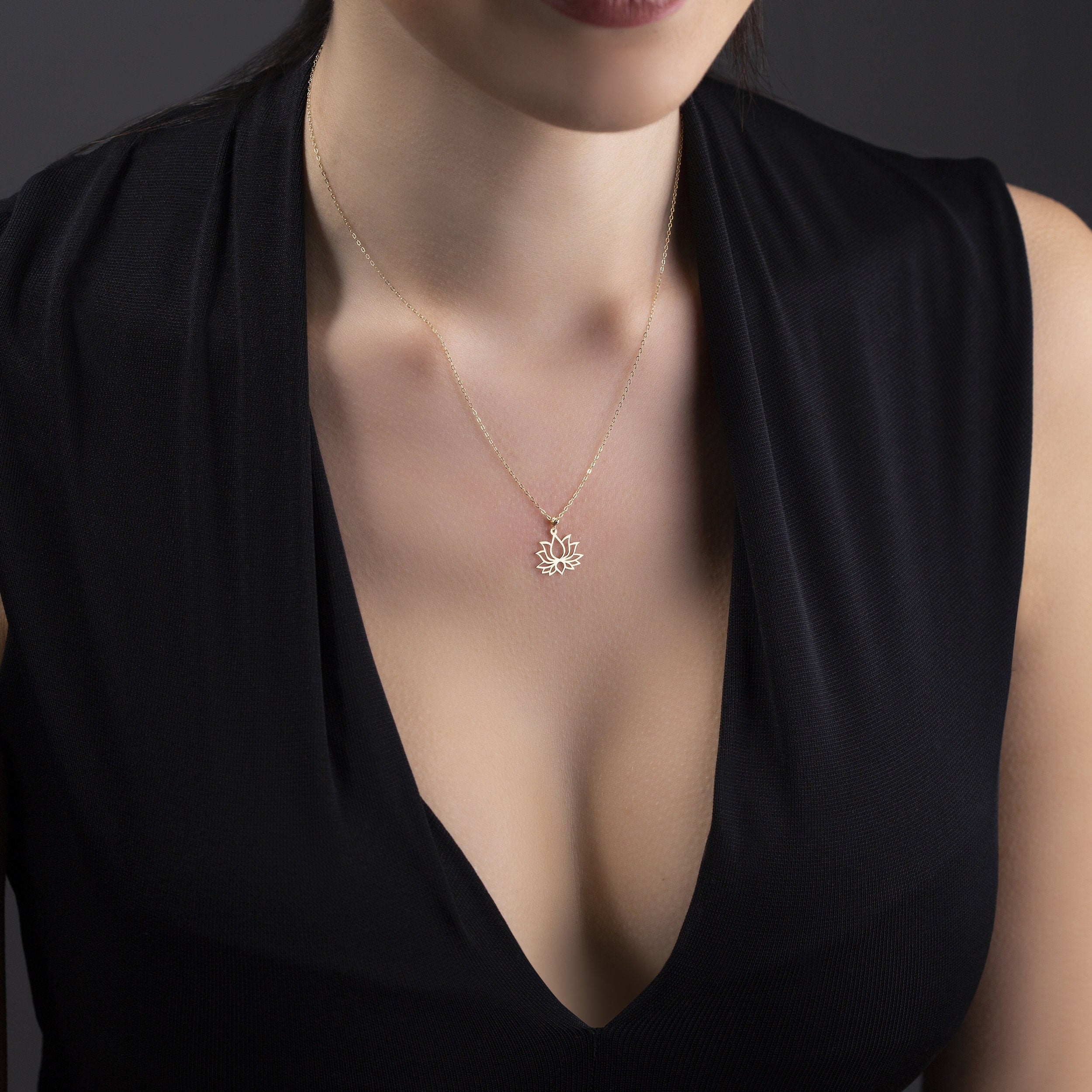 14K gold lotus flower pendant necklace  symbolizing purity and spiritual balance.