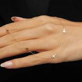 14K gold necklace with multiple small cross charms elegant and minimalistic.