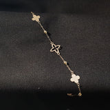 Elegant 14K gold bracelet featuring alternating solid and hollow clover charms with gold bead accents