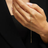 14K gold bracelet with four-leaf clover charm and gemstone details