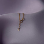 14K gold bracelet with four-leaf clover charm and gemstone details